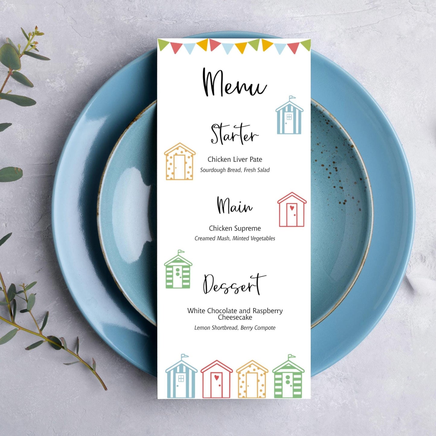 A wedding table menu card with a beach hut themed design on it.