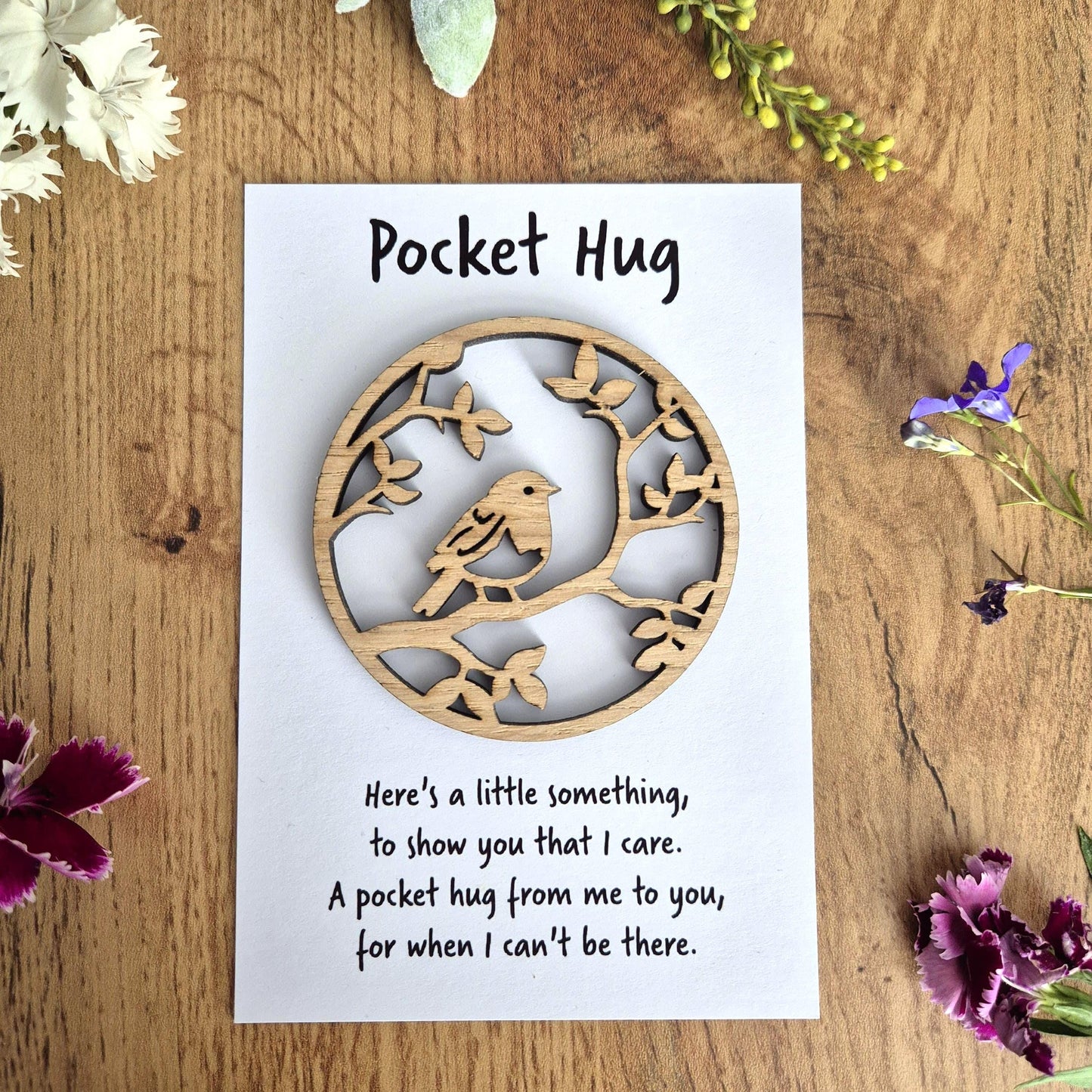 Small wooden pocket hug with a robin design and accompanying comfort message
