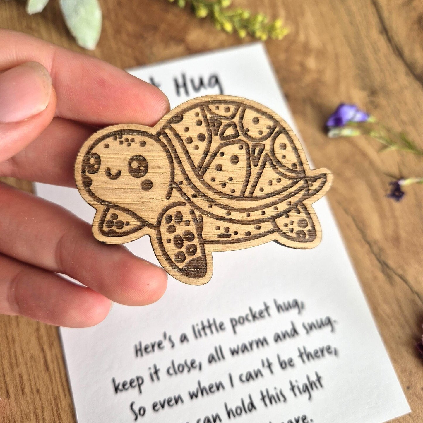 Wooden turtle-shaped pocket hug with a sentimental message on the white backing card.