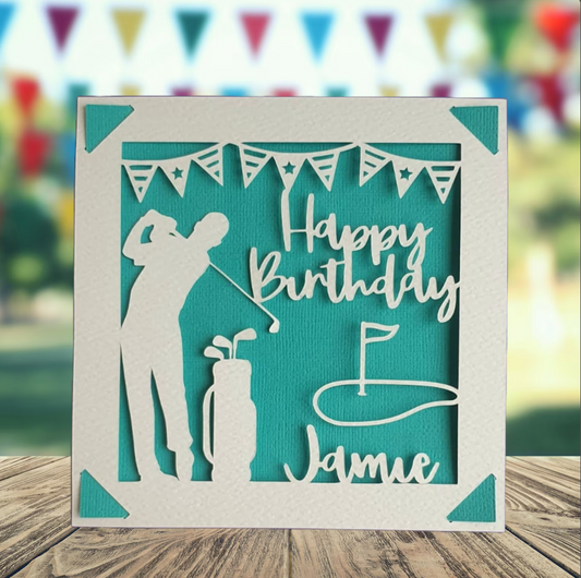 A personalised golfing birthday card for someone who loves golf. The card is fully customisable with the recipient's name. The card features a figure playing golf, with their golf club, bag and a cut out of a golf hole with flag. The background colour is turquoise.