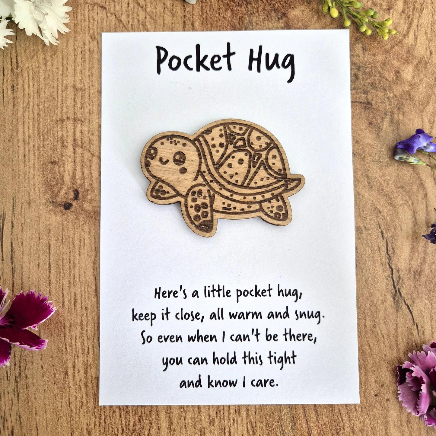 Wooden tortoise 'Pocket Hug' on a white card with thoughtful text on.