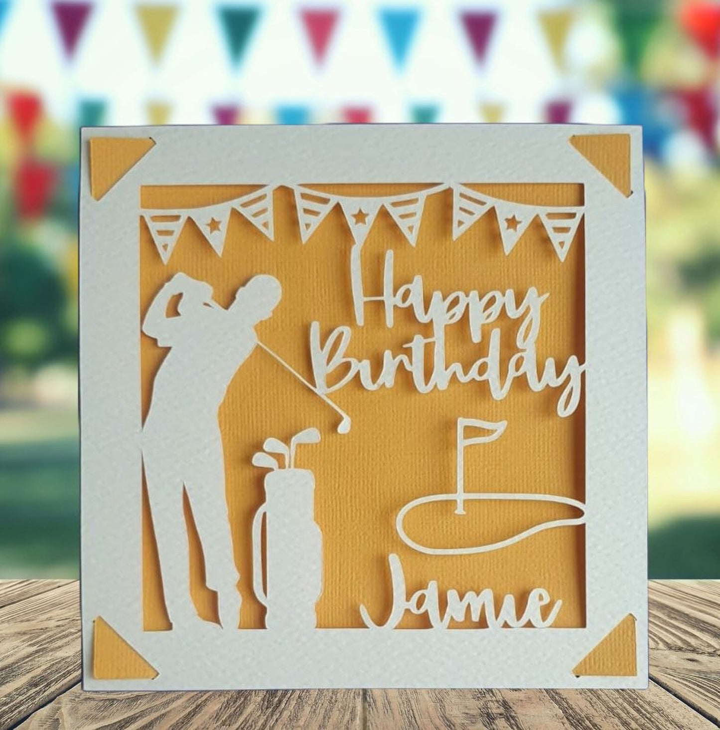 A personalised golfing birthday card for someone who loves golf. The card is fully customisable with the recipient's name. The card features a figure playing golf, with their golf club, bag and a cut out of a golf hole with flag. The background colour is orange.