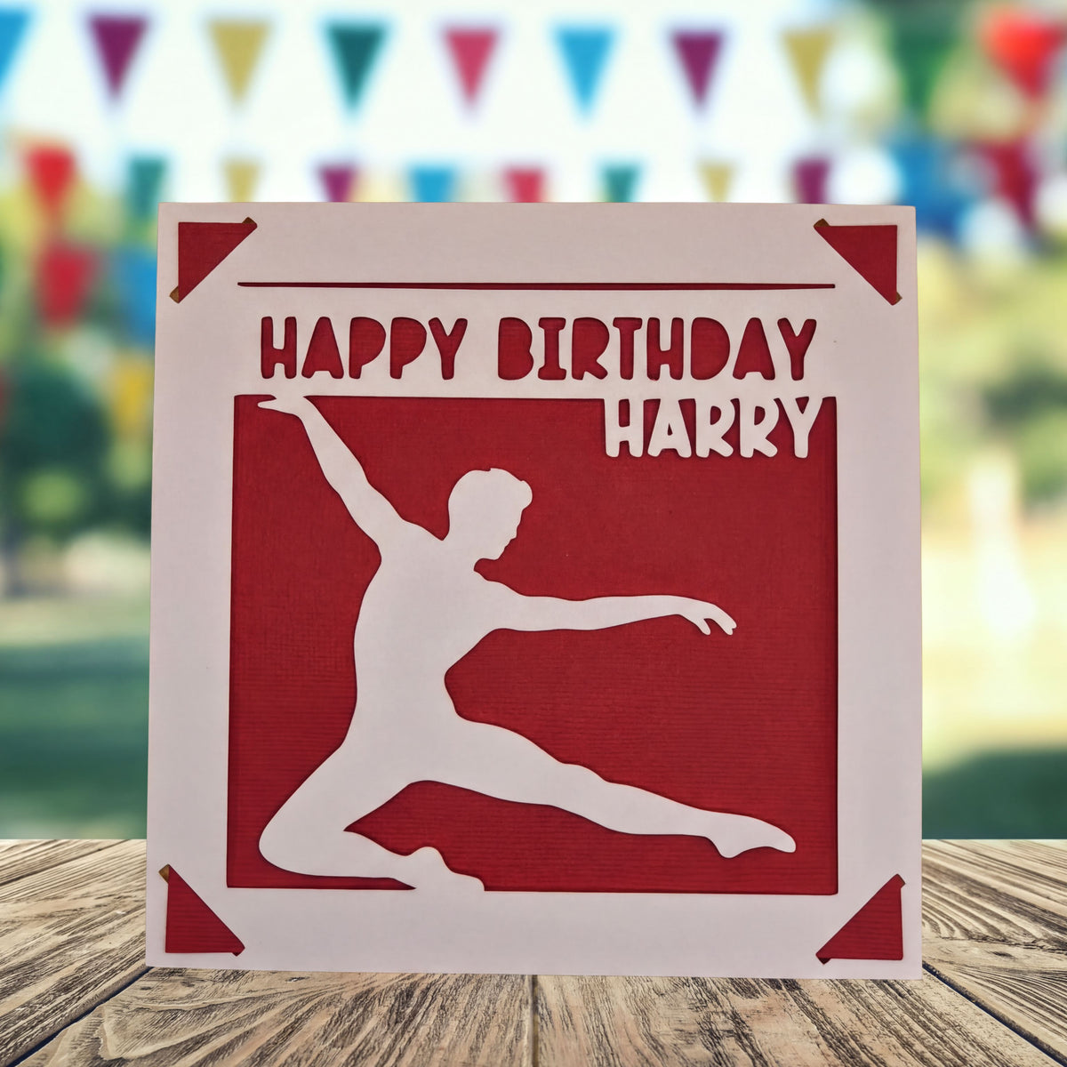A red birthday card with a silhouette of a person dancing, and the text "Happy Birthday Harry" written on it.