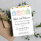 A beach hut themed wedding invitation with colourful huts, personalized with the names of the couple and the details of the wedding venue, placed on a kraft brown envelope. Made from textured quality cardstock.