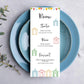 A wedding table menu card with a beach hut themed design on it.