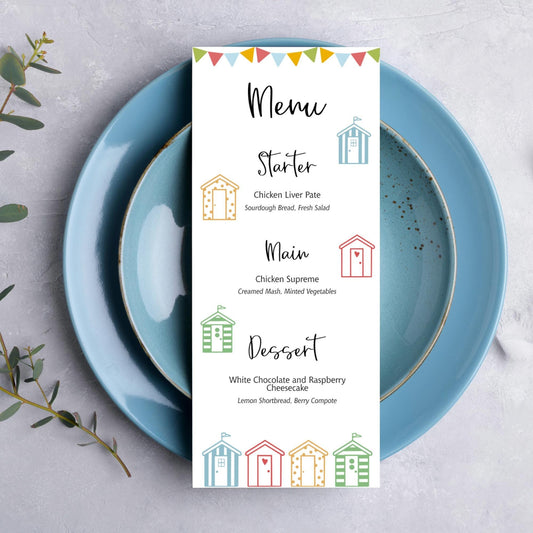 A wedding table menu card with a beach hut themed design on it.