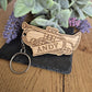 A Brass band themed wooden keyring in the shape of a cornet or trumpet with a name on it.