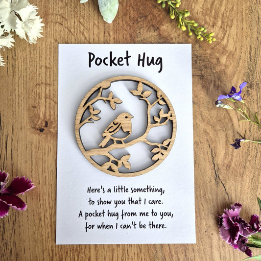 Small wooden pocket hug with a robin design and accompanying comfort message