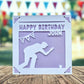 A white greeting card with a silhouette of a person kneeling, playing crown green bowling and the text "Happy Birthday John" printed on it.