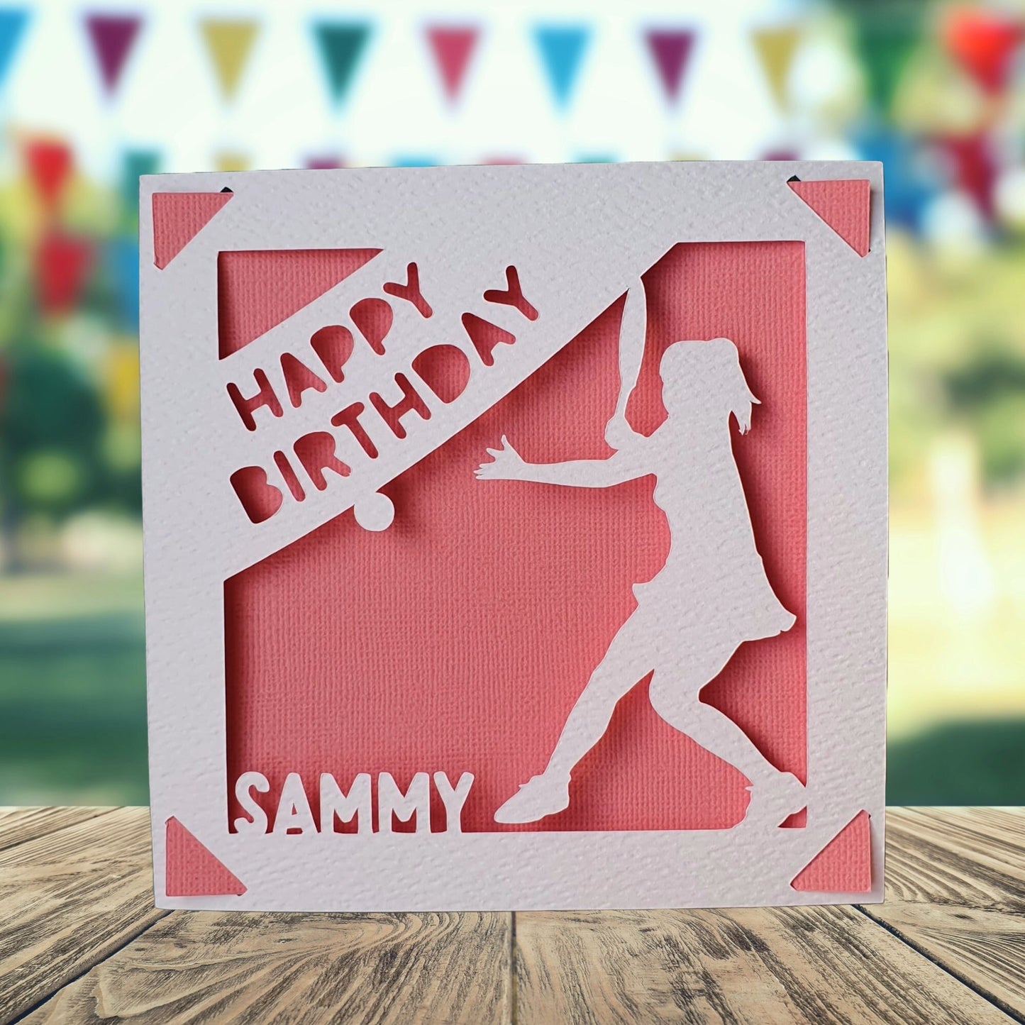 A personalised birthday card with a pink background, featuring a silhouette of a female tennis player and the text 'Happy Birthday' with the name of the recipient.