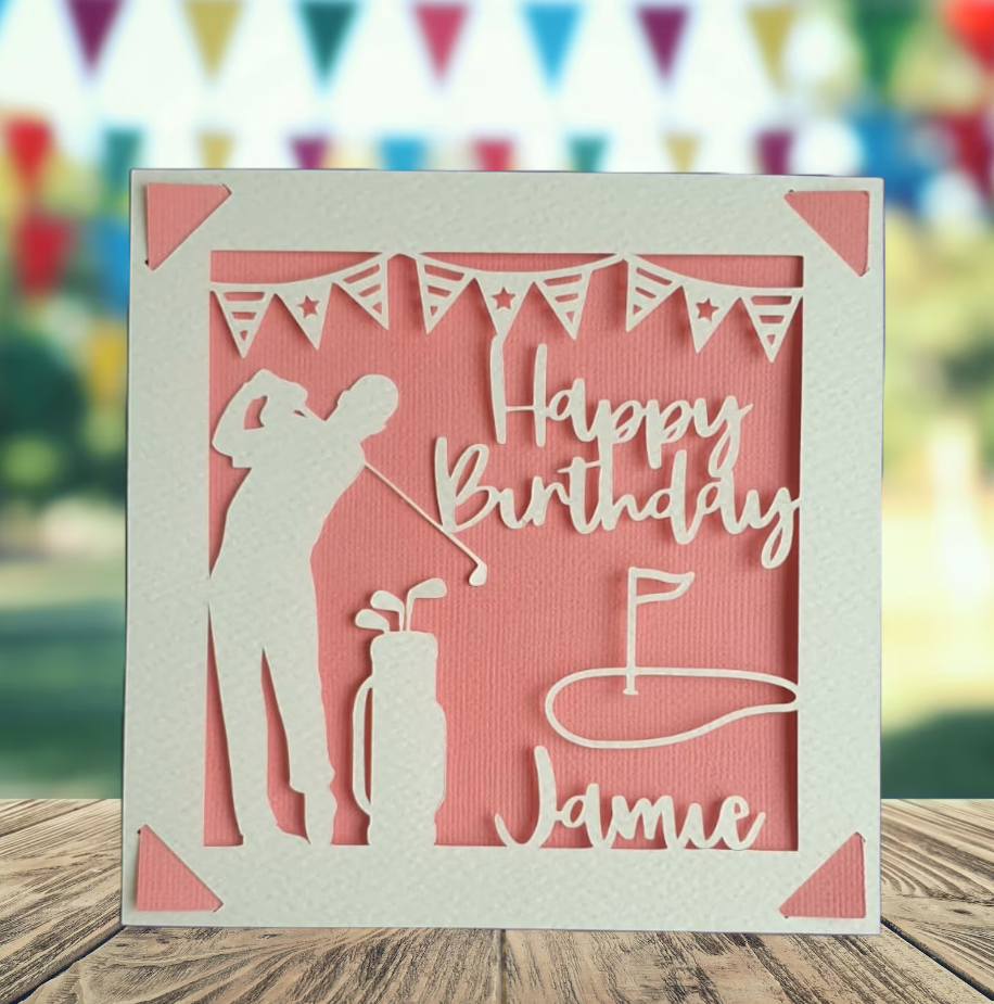 A personalised golfing birthday card for someone who loves golf. The card is fully customisable with the recipient's name. The card features a figure playing golf, with their golf club, bag and a cut out of a golf hole with flag. The background colour is pink.