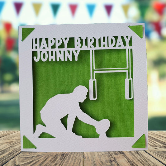 Personalised greeting birthday card with a rugby player silhouette on the front, with a 'happy birthday' message on the front with the recipient's name. The card background is green.